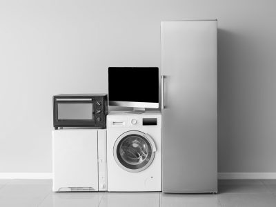 Different household appliances near light wall